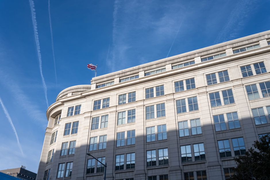 An elegant office building under a clear blue sky in Washington, D.C.