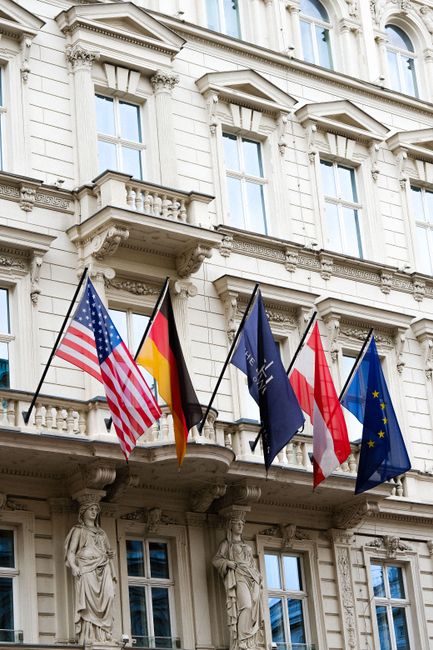 International flags displayed on a government building facade