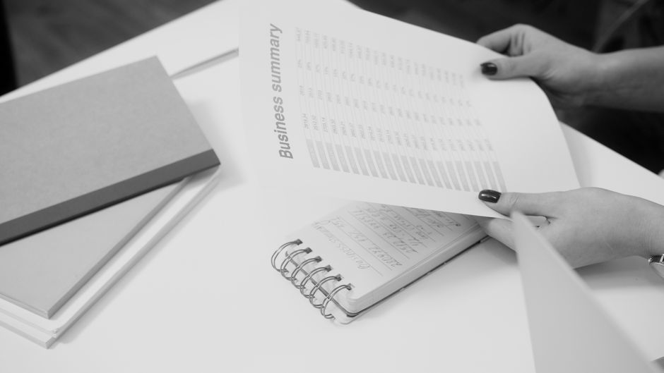 A business analyst reviews an offering document as investors assess new equity supply and market liquidity.