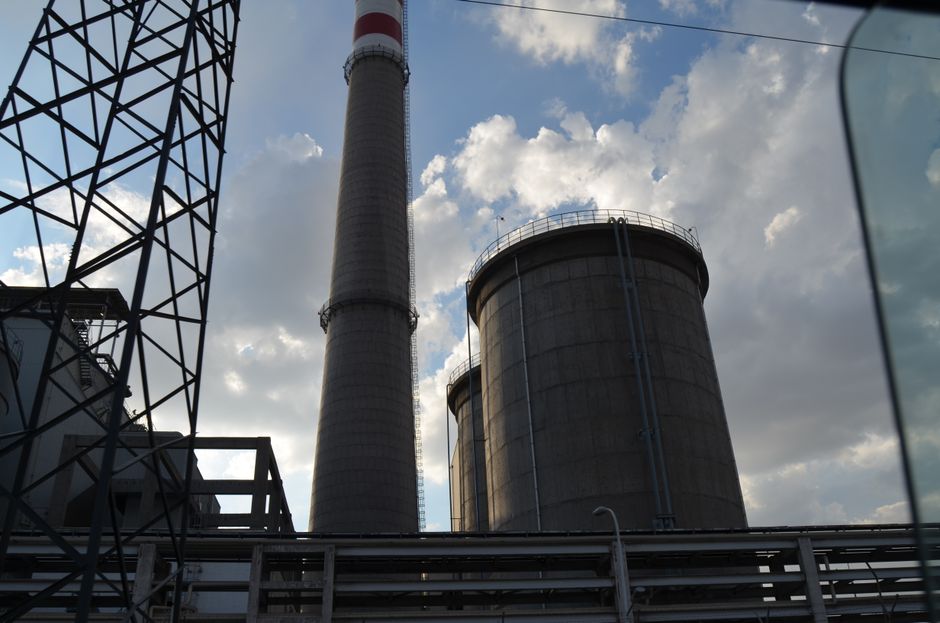 Industrial facility under a cloudy sky representing the capital intensity behind cloud and AI infrastructure