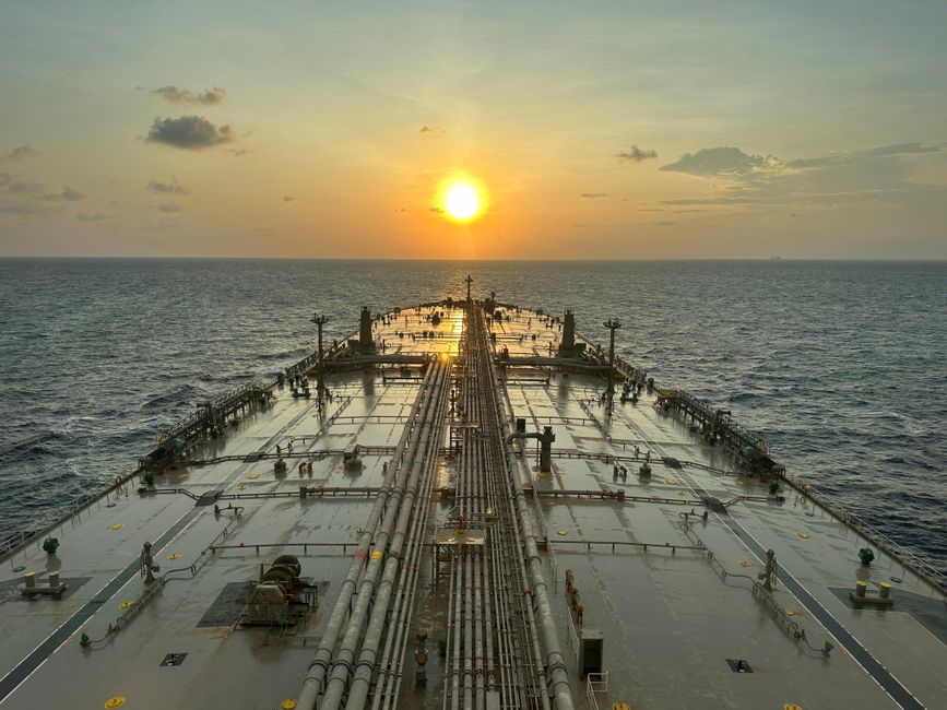 An oil tanker at sea during sunset