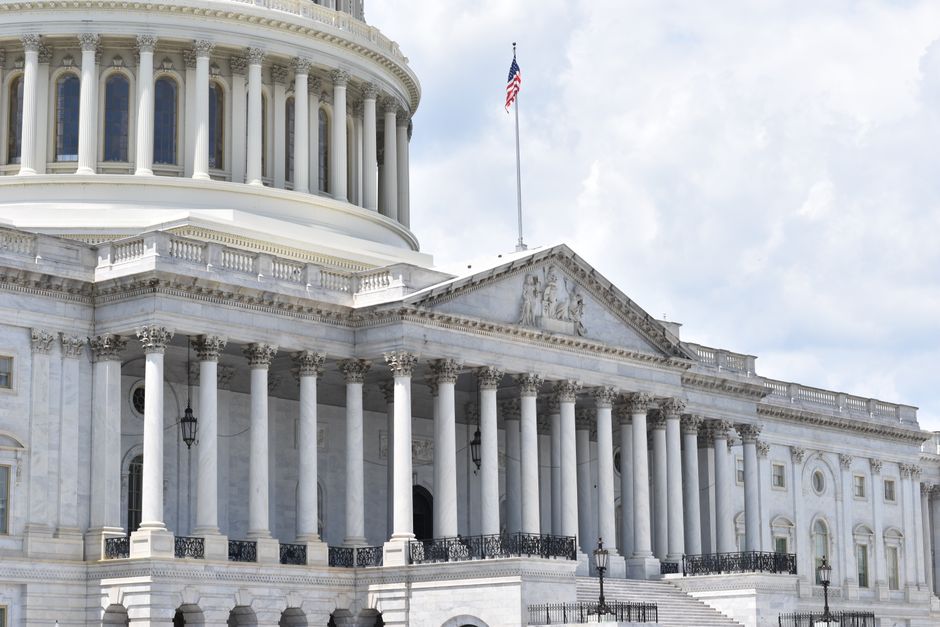 A neoclassical government building with columns, representing legislative action