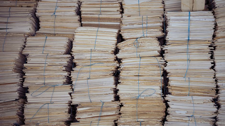Neatly organized stacks of bound paper bundles, evoking the volume of equity issuance documents and share supply.