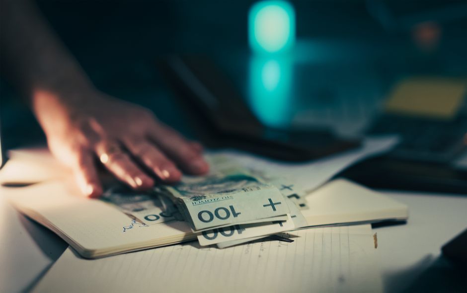 Capital-markets paperwork and cash on a desk represent IPO issuance and the absorption of new equity supply