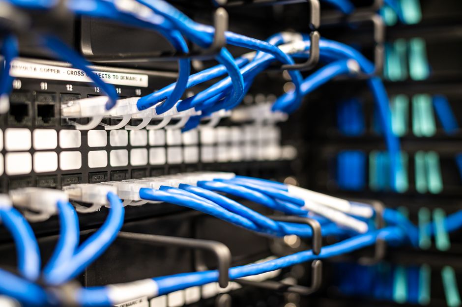 Blue network cables connect enterprise computing infrastructure that supports expanding software workloads.
