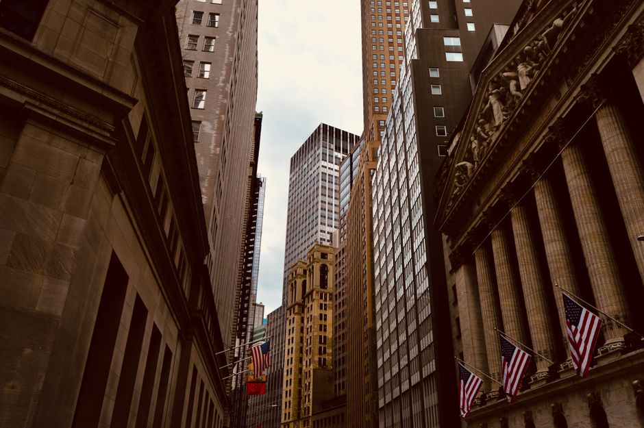 Wall Street skyline in New York City, showcasing iconic financial district architecture and urban density.