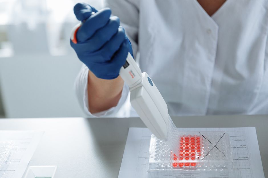 Scientist using pipette in laboratory