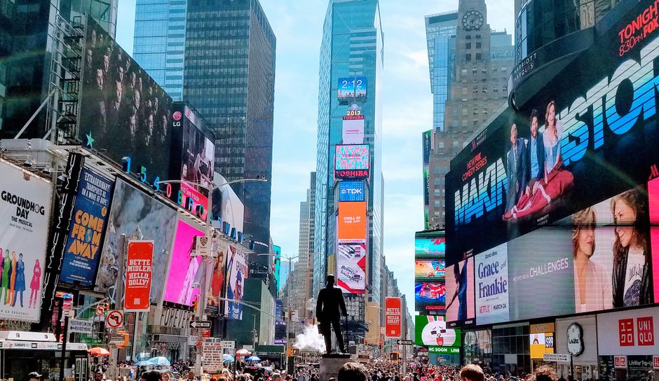 Times Square in New York, a public-market hub where listings and trading activity meet.