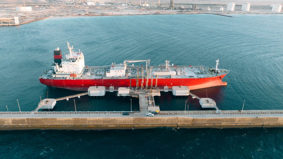 A cargo ship docked at an industrial port