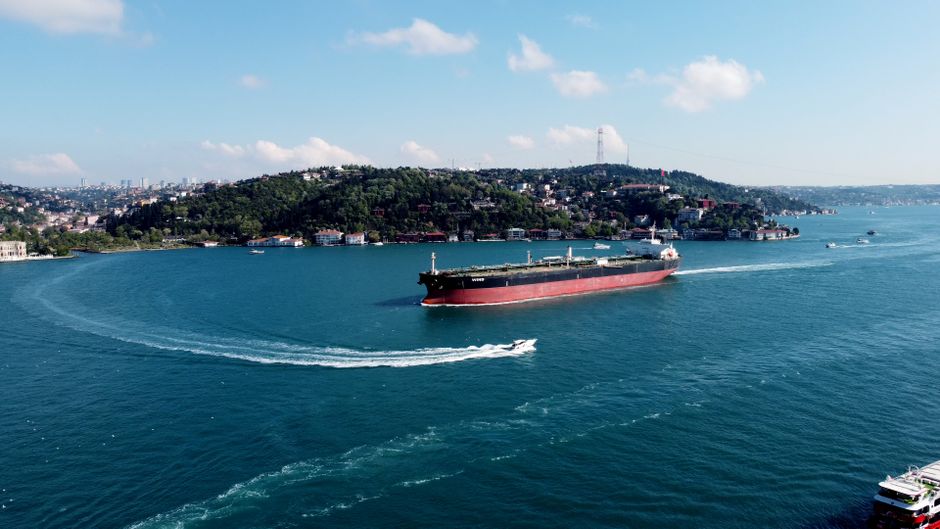 Cargo ship navigating a narrow maritime passage