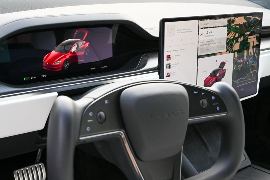 Interior of a modern electric vehicle with advanced touchscreen displays and autonomous driving controls