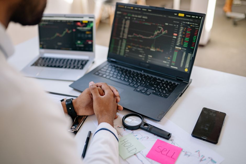 Business analyst reviewing market data on screens