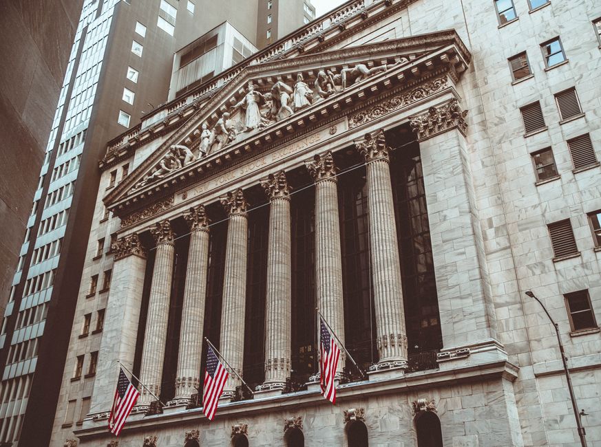 Historic New York Stock Exchange building facade in vintage style, with neoclassical columns.