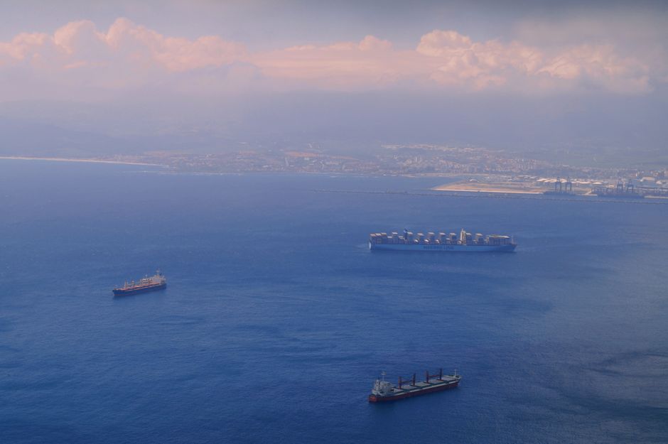 Aerial view of cargo ships navigating near a coastline