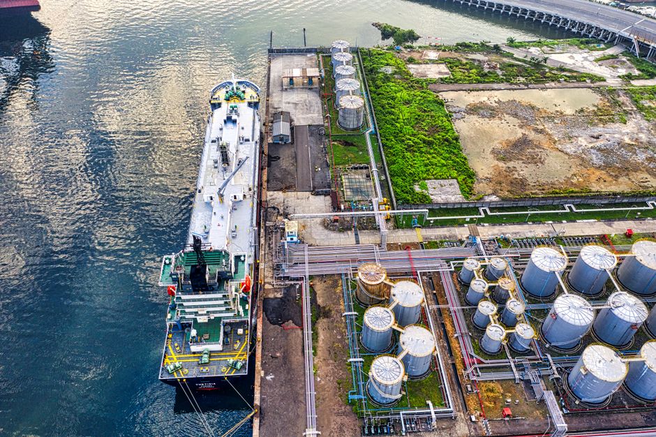 Ship docking beside industrial export infrastructure