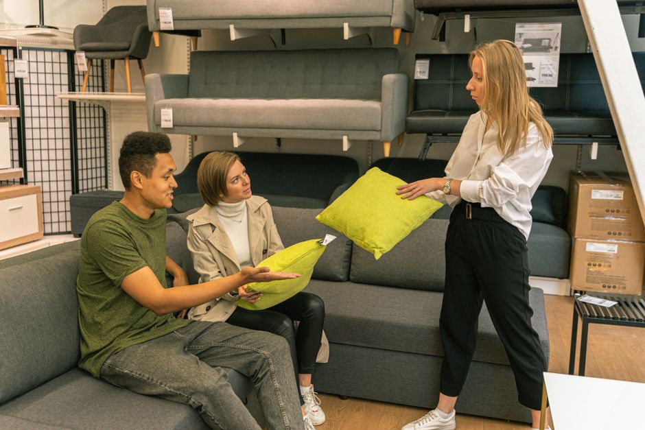 A furniture-shopping setting represents selective discretionary demand under elevated financing costs.