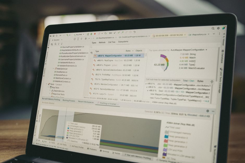 A laptop displays analytics and software code used in enterprise technology workflows.