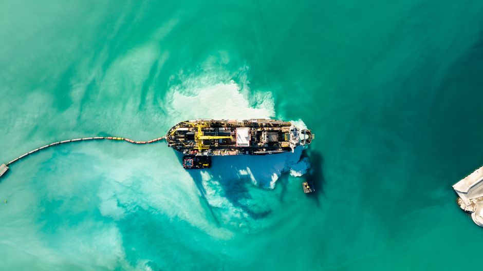 An industrial vessel crosses open water as Gulf exporters rely on alternative transfer logistics