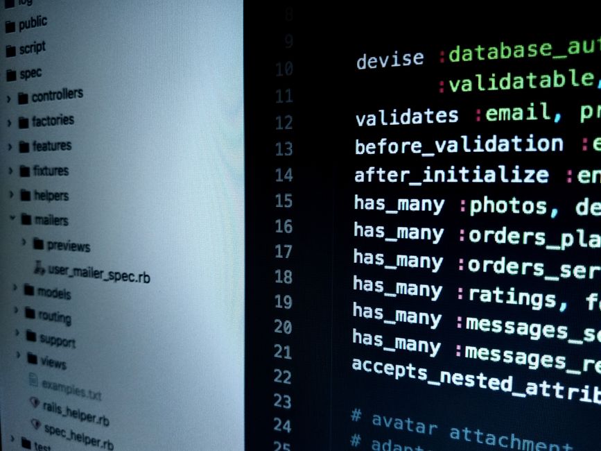 Computer monitor displaying programming code on a dark screen, representing software development and cloud infrastructure.