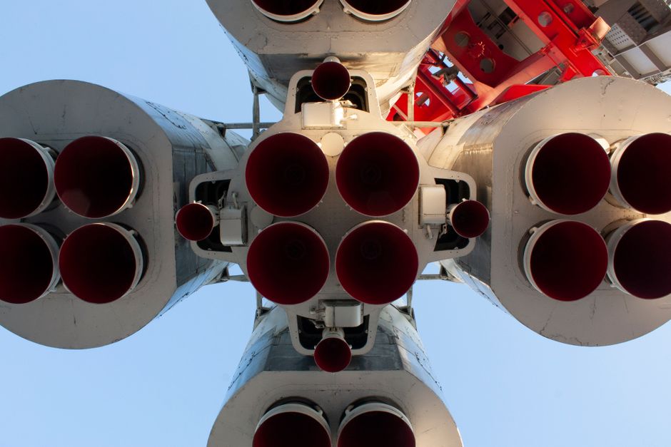 Close-up view of rocket engine nozzles from below, representing aerospace launch technology.