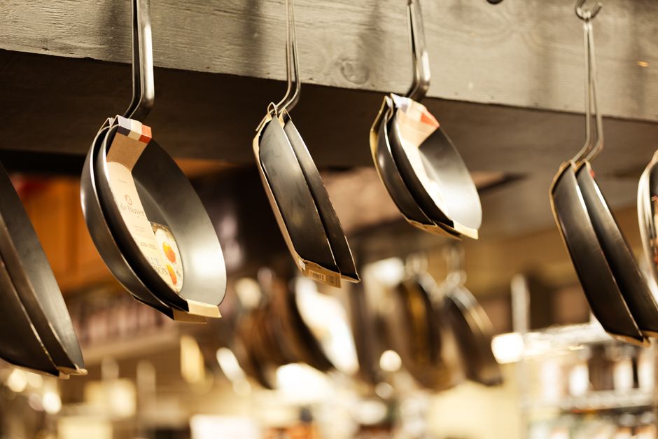 Kitchenware products stand in a retail display, reflecting the branded and category-specific nature of consumer demand.