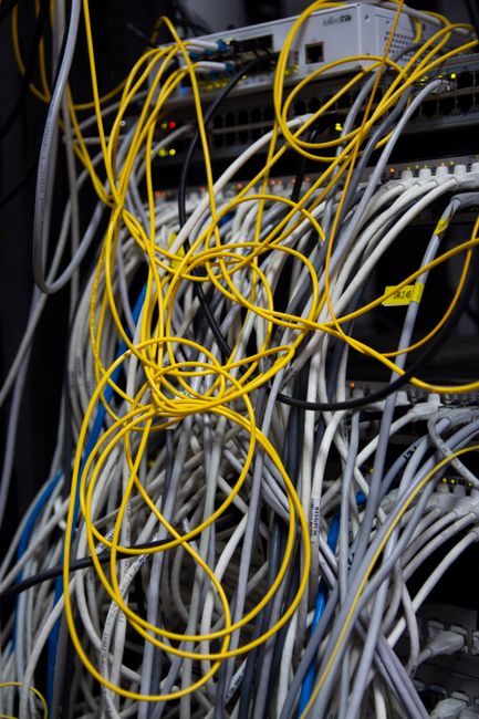 Network cables and fiber optic connections in a server rack