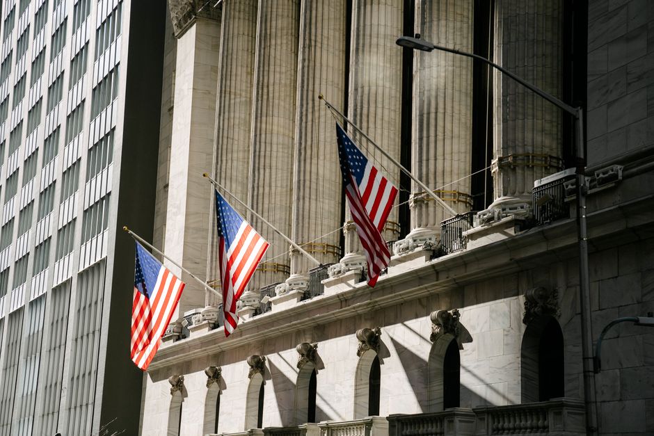 American flags outside a large financial-district-style building