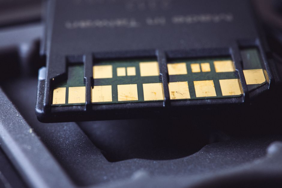 Macro close-up of SD card connector pins on a circuit board, representing flash memory technology