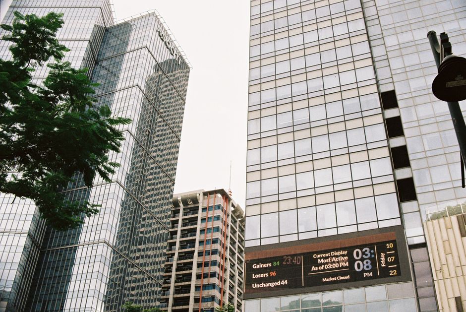 Modern skyscrapers with digital displays in a bustling urban financial district