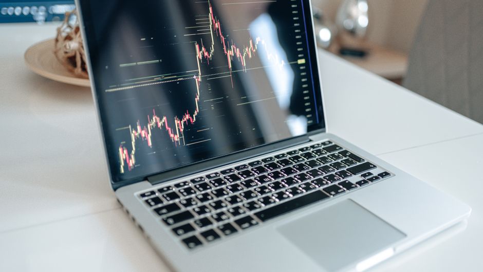 A laptop displays a market graph as investors assess new share supply and trading liquidity.