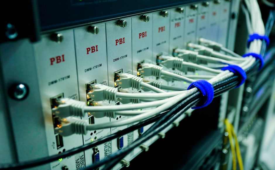 Close-up of ethernet cables plugged into a network switch, representing the cloud-software infrastructure Snowflake and Datadog are monetizing.