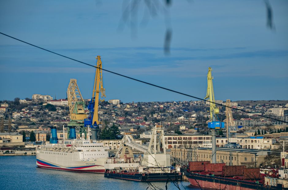 Aerial view of an industrial harbor with ships and cranes