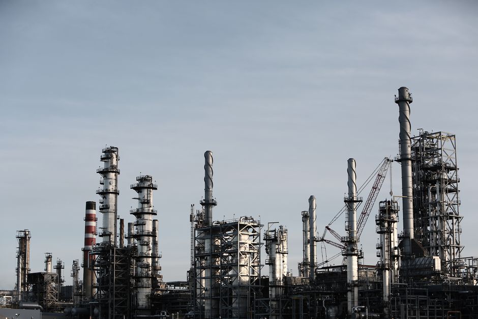 Industrial plant with tall chimneys against a clear sky.