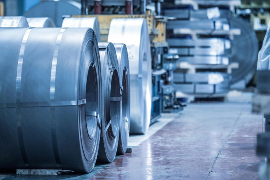 Close-up of coiled metal sheets in an industrial factory. Precision engineering materials.