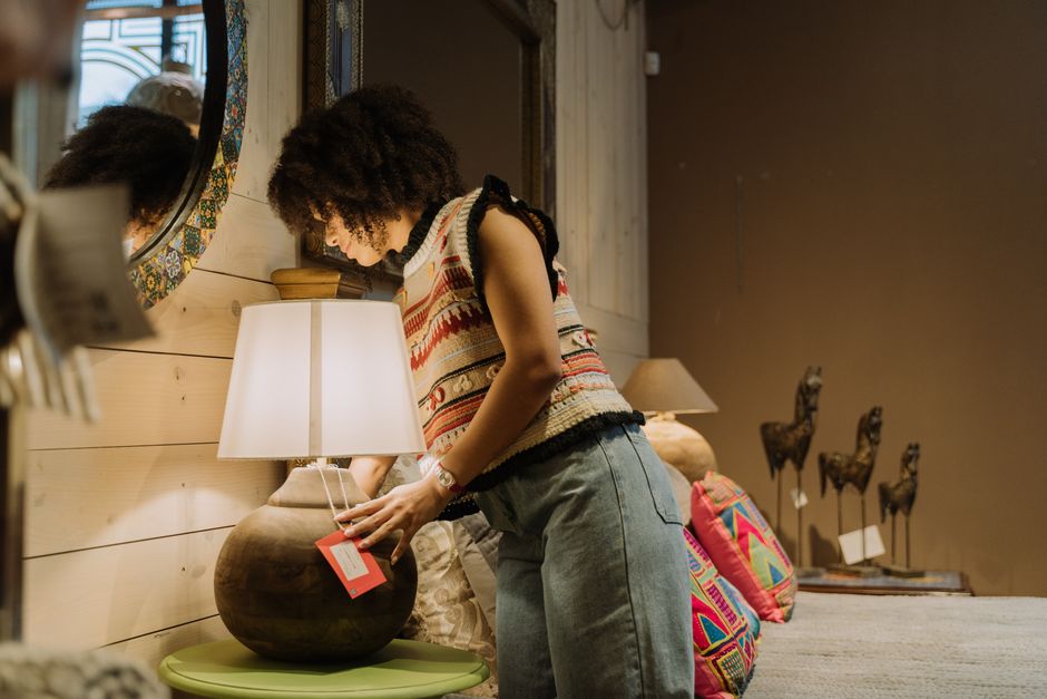 Retail shopper examining a home-furnishing purchase in a store