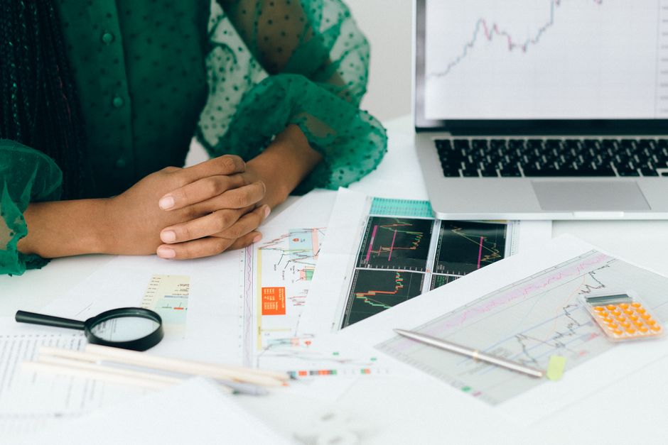 A financial analyst reviews market data and issuance documents as investors assess new equity supply and liquidity.