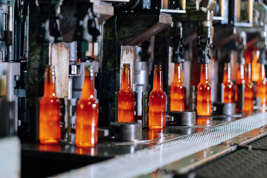 Glass bottles moving along a production line in a modern bottling factory