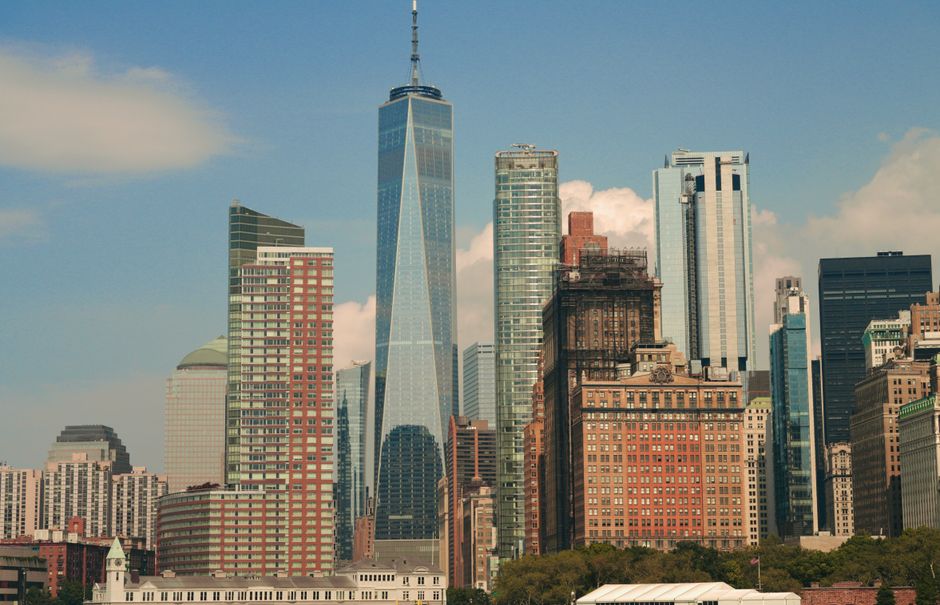 A cityscape of New York City featuring One World Trade Center and modern skyscrapers in the financial district, representing the market's record-high close.