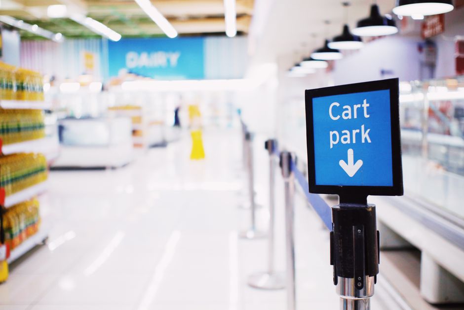 A supermarket aisle with a shopping cart area