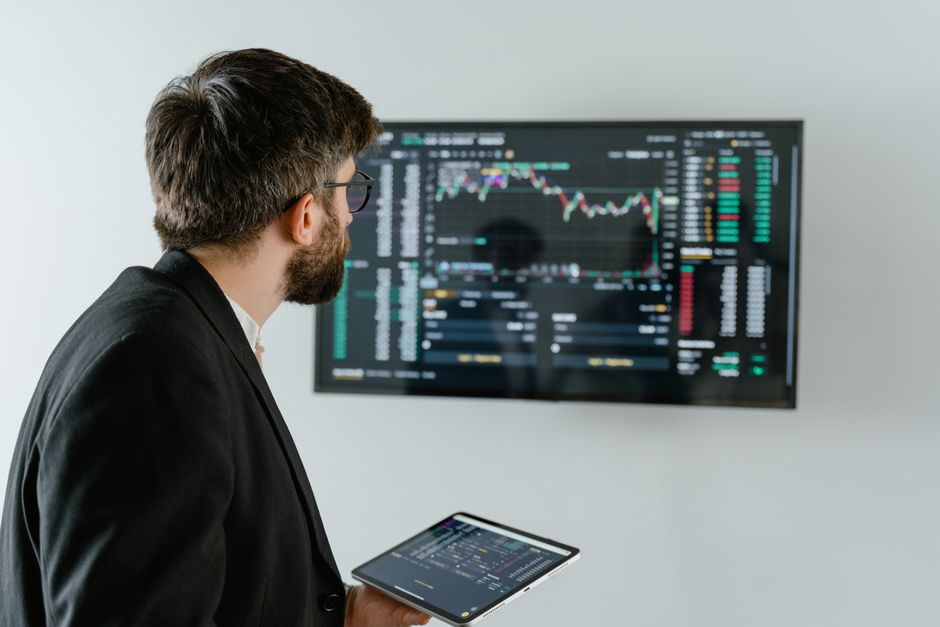 Professional reviewing financial data on a tablet