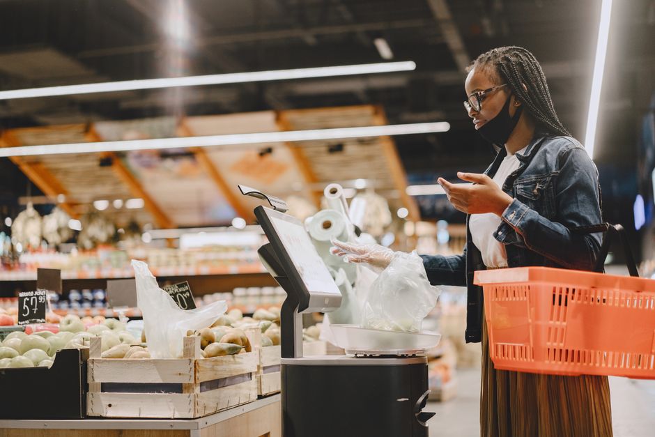 Woman shopping for groceries in a supermarket aisle