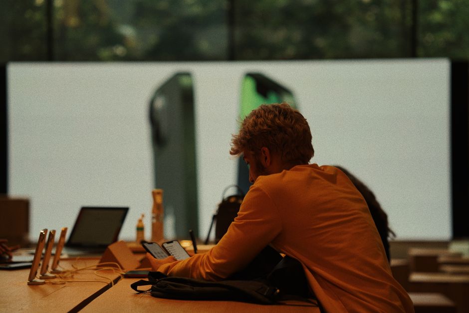 A customer examines smartphones in a modern Istanbul gadget store.