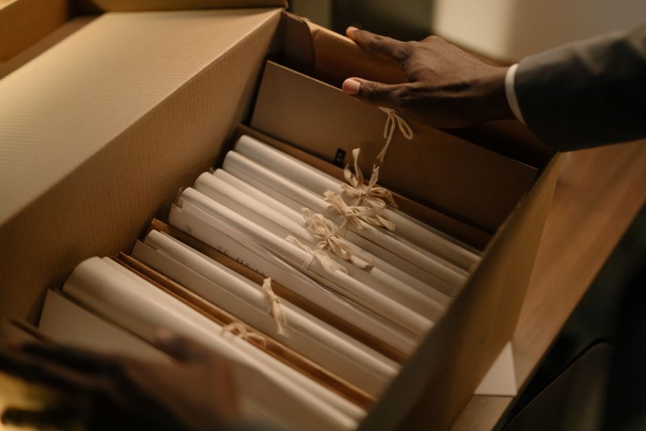 Hands organizing corporate files related to public-offering research