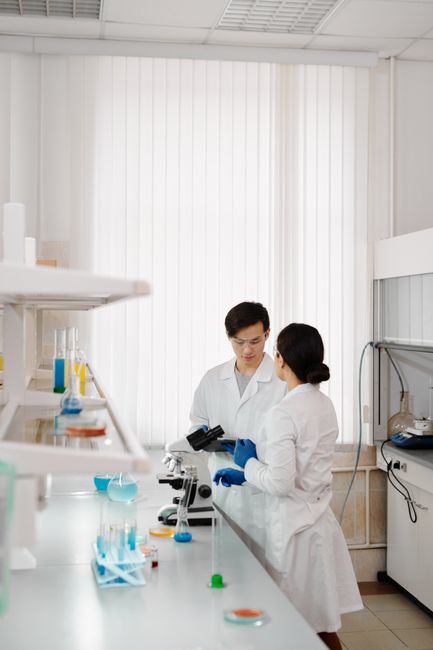 Two scientists in lab coats working in a sophisticated laboratory setting.