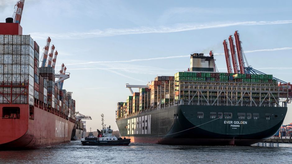 Cargo ships moving through a busy commercial port