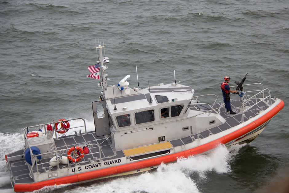 A coast guard patrol boat navigating open ocean waters, representing maritime security operations.