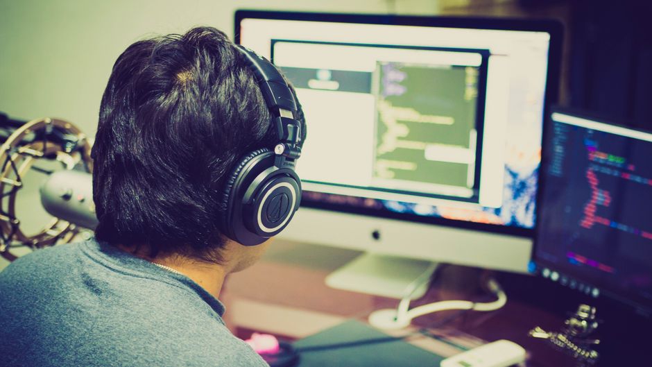 A software developer monitoring cloud application performance and analytics