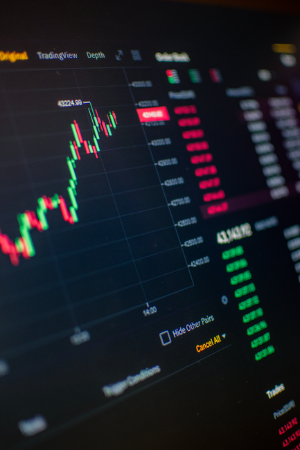 A digital screen showing financial market trading data and graphs.