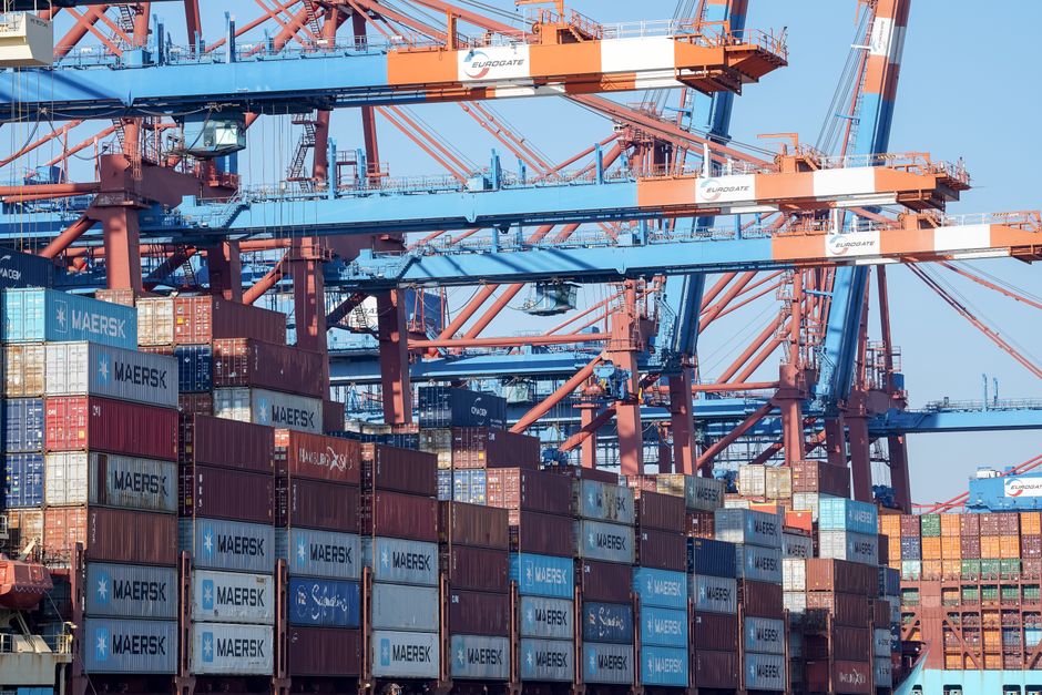 Shipping containers and cranes at a major port illustrate the freight network feeding home-furnishings inventories