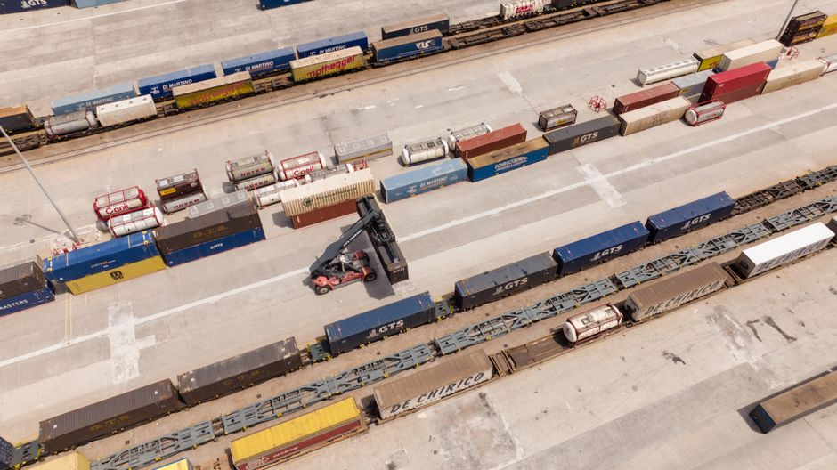 Aerial view of stacked shipping containers at a logistics hub